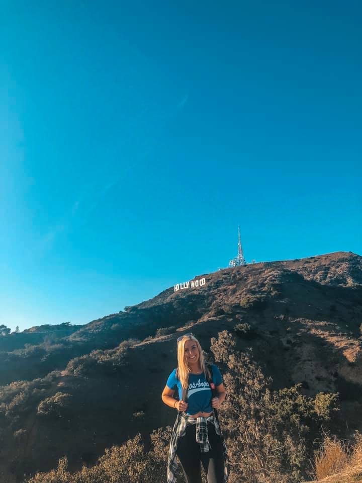 Posing with the Hollywood sign in LA after doing a solo hike