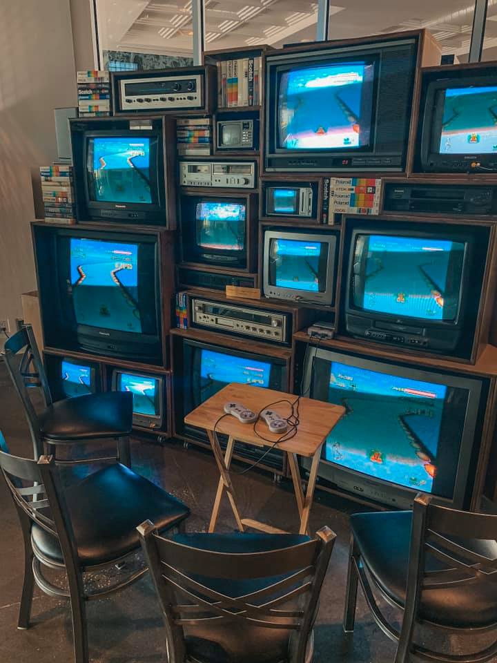 several different sized tvs connected to a classic Nintendo game