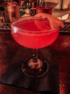 A pink cocktail with a twist of lemon from a downtown Raleigh bar-- Watts & Ward.