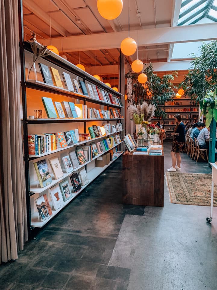 a row of bookshelves in Brewery Bhavana in downtown Raleigh