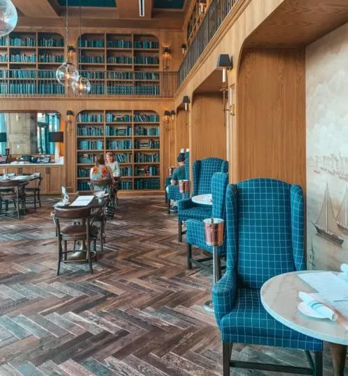 more dining areas and blue books covering shelves at one of st.pete's best coffee shops