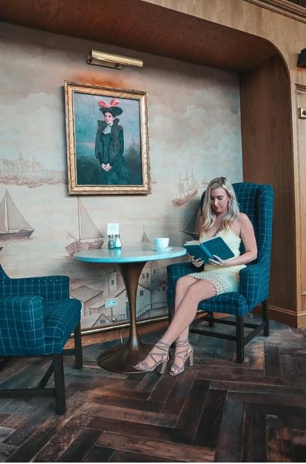 Woman reading at one of the best coffee shops in downtown St. Pete, The Library