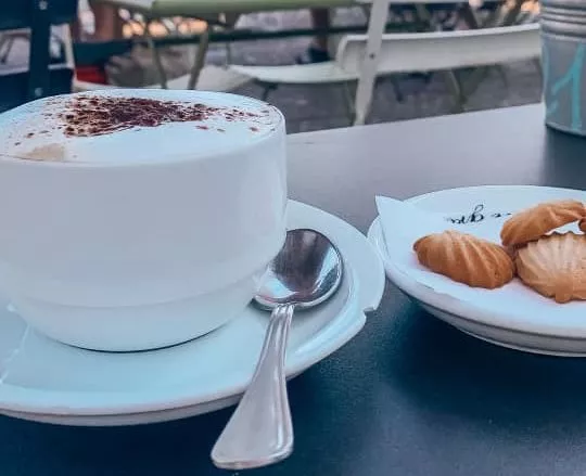 an Italian cappuccino with some mini cookies 