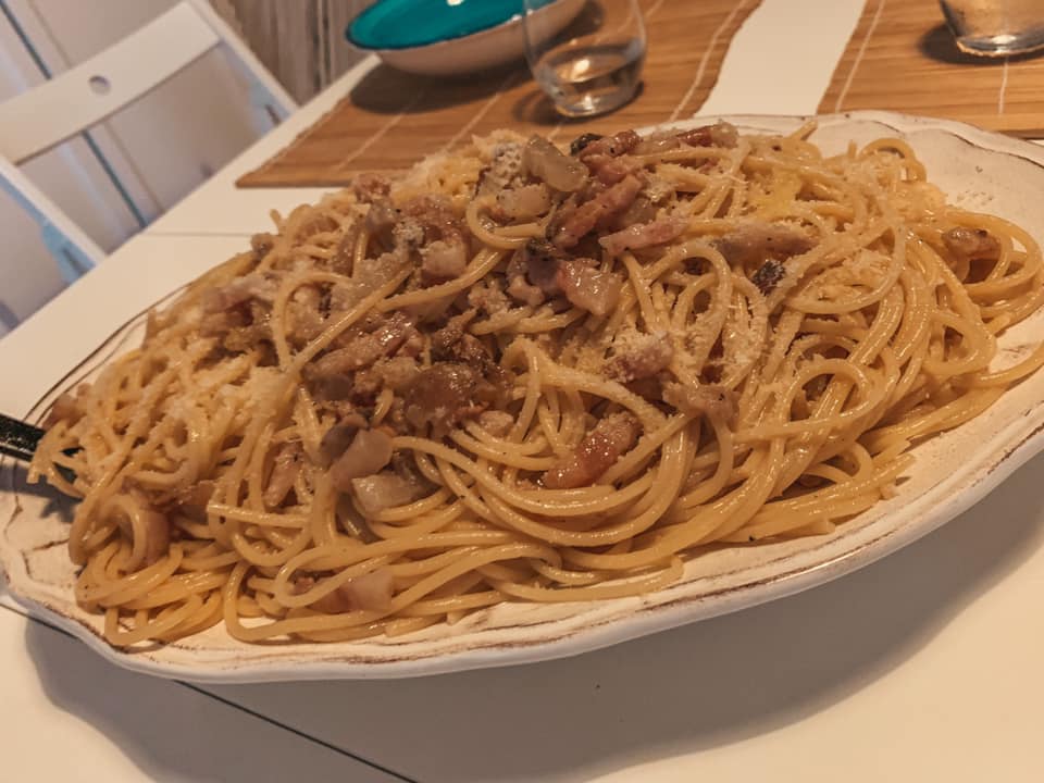 popular foods in Italy, a heaping pile of plated carbonara