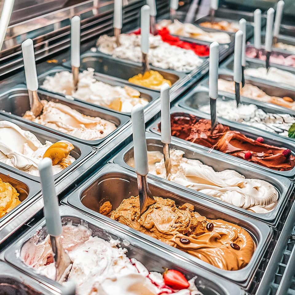 an array of gelato flavors in a cafe shop in Italy