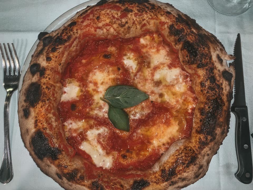 a cheese pizza with a fluffy crust, easily one of the most popular foods in Italy