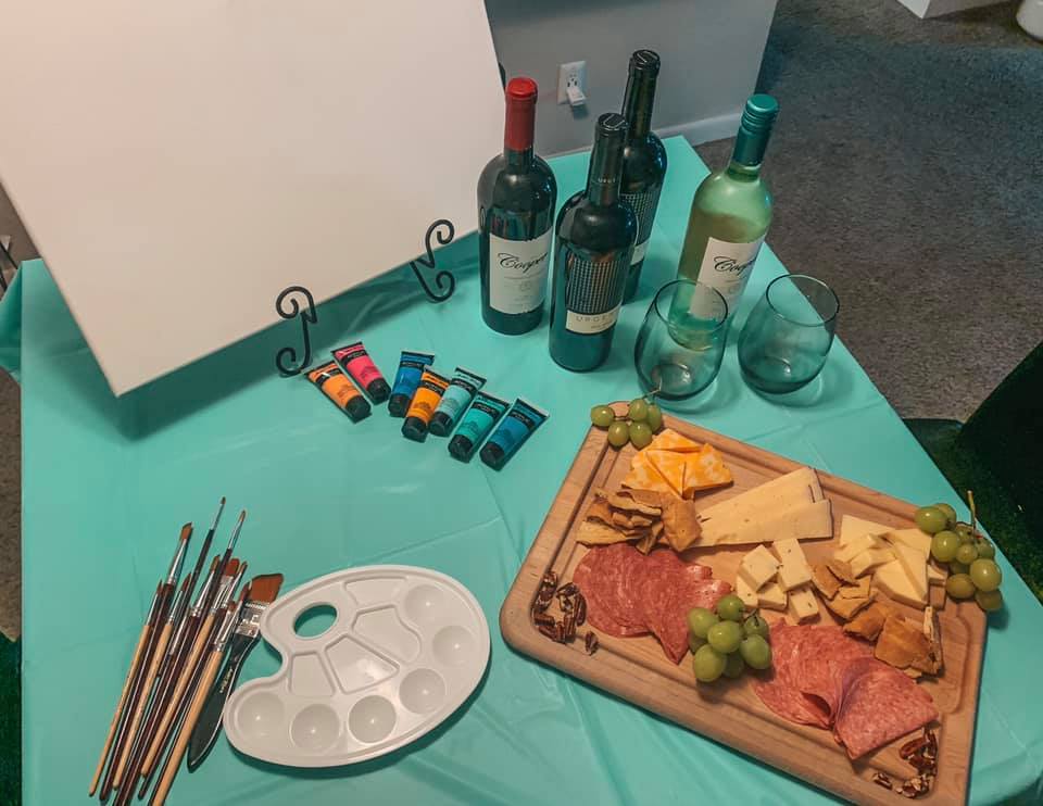 Stay in paint night with charcuterie board and wine