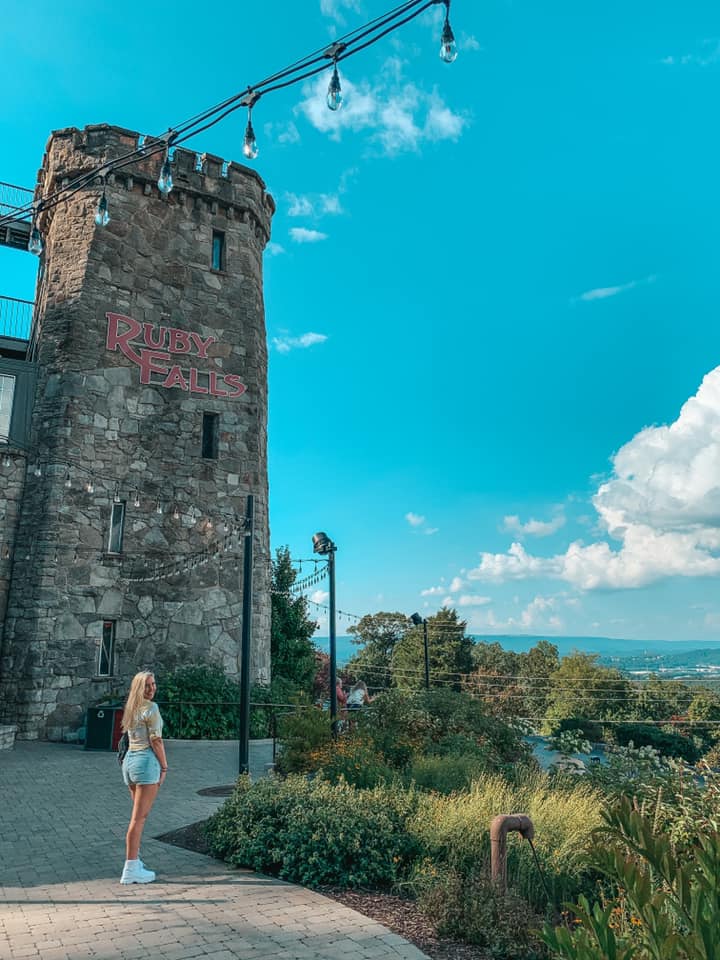 standing in front of the entrance area of Ruby Falls in Chattanooga Tennessee