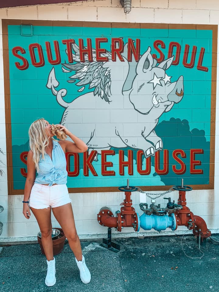 Enjoying a pulled pork sandwich in front of Southern Soul Smokehouse mural