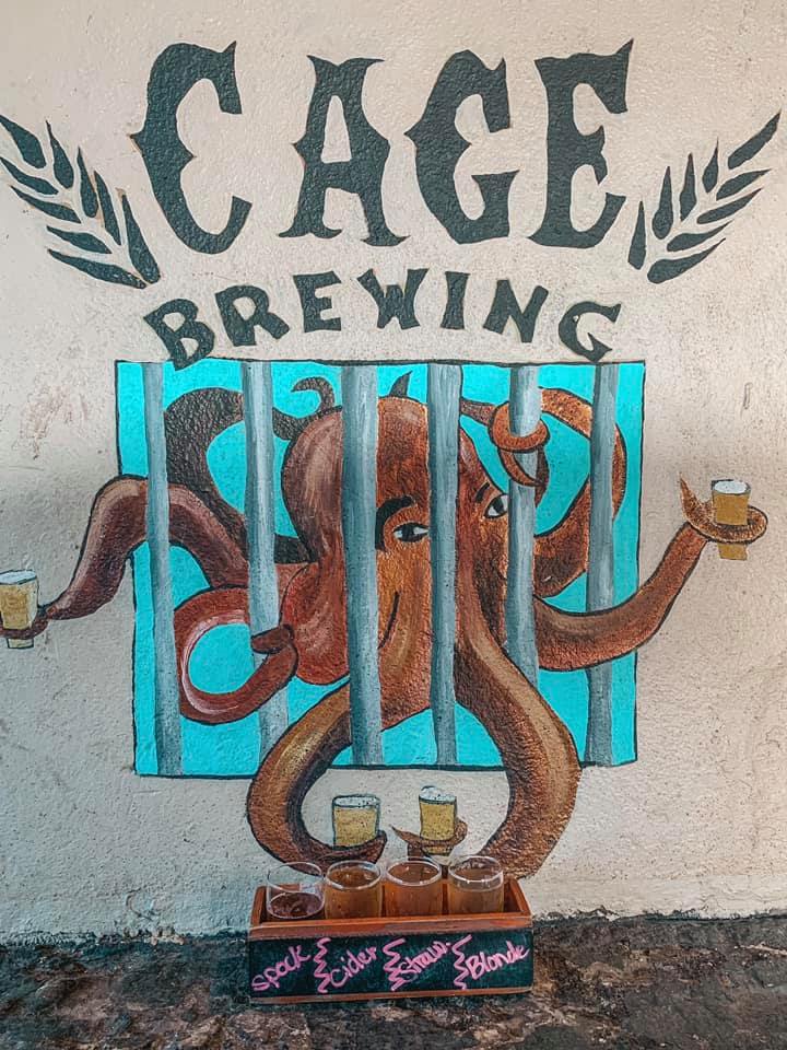 Cage brewing mural of octopus holding beer with arms out of cage