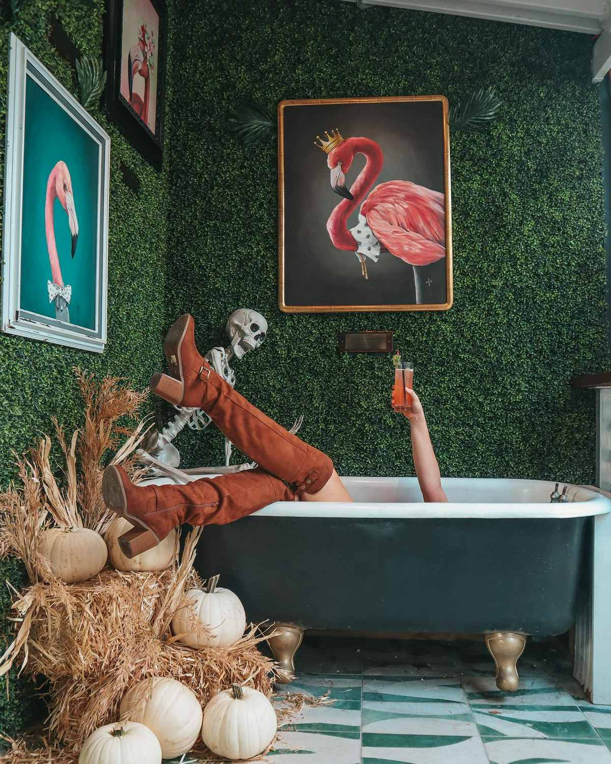 Woman in tub at Mandarin Heights holding up a cocktail