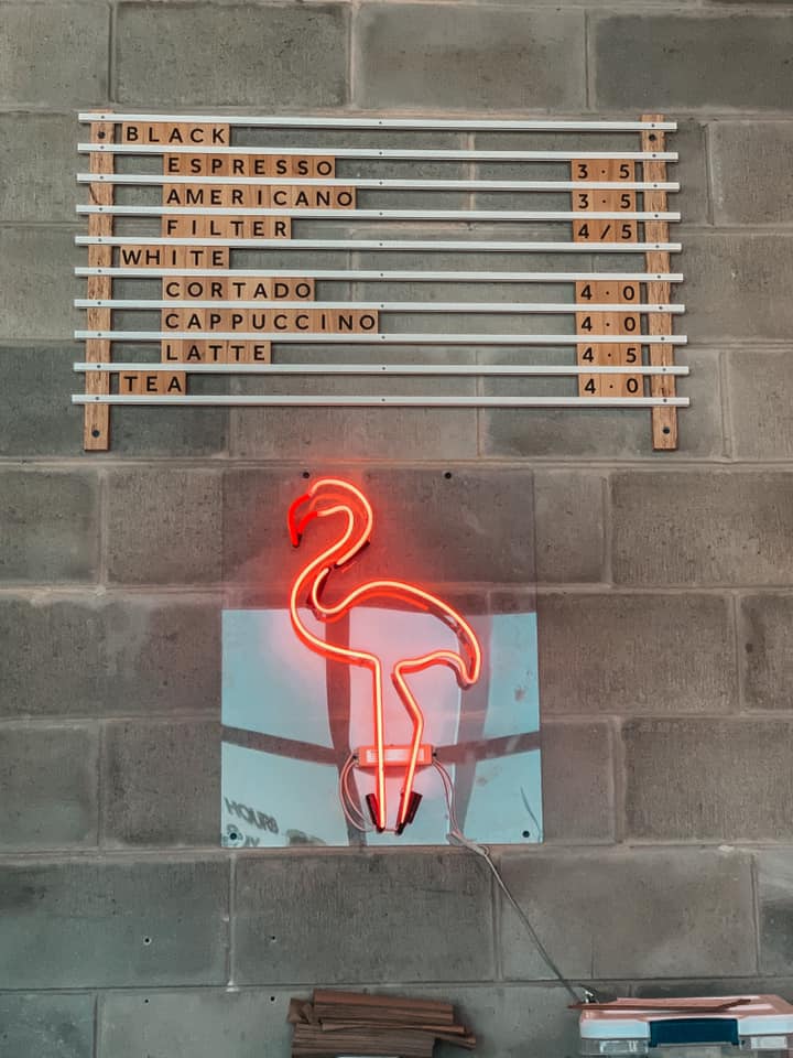 Scrabble style coffee menu with neon flamingo below at The Overton in Sarasota best breakfast restaurant in Sarasota