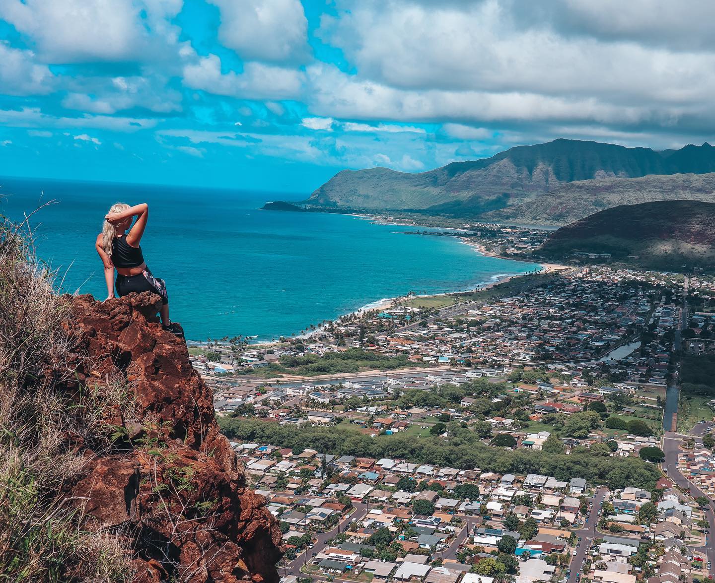 Woman at a lookout point of the pink pillbox hike in Oahu Hawaii