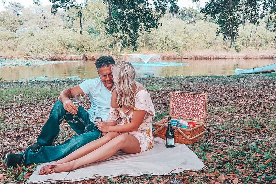 Couple enjoying a picnic date together at a beautiful Airbnb in Ocala, Florida for a nice weekend getaway