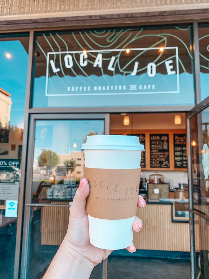 Holding a hot latte in front of Local Joe, one of the best coffee shops in Honolulu