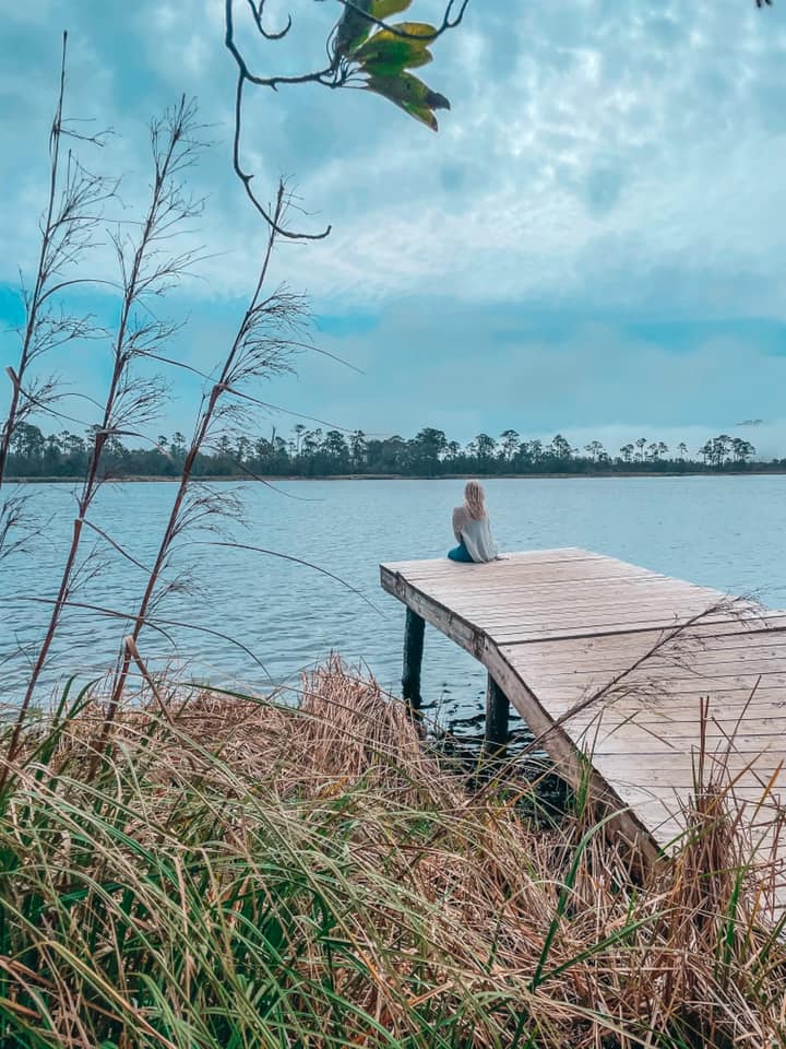 Sitting on a dock at a lake in Gulf State Park in Orange Beach, Alabama