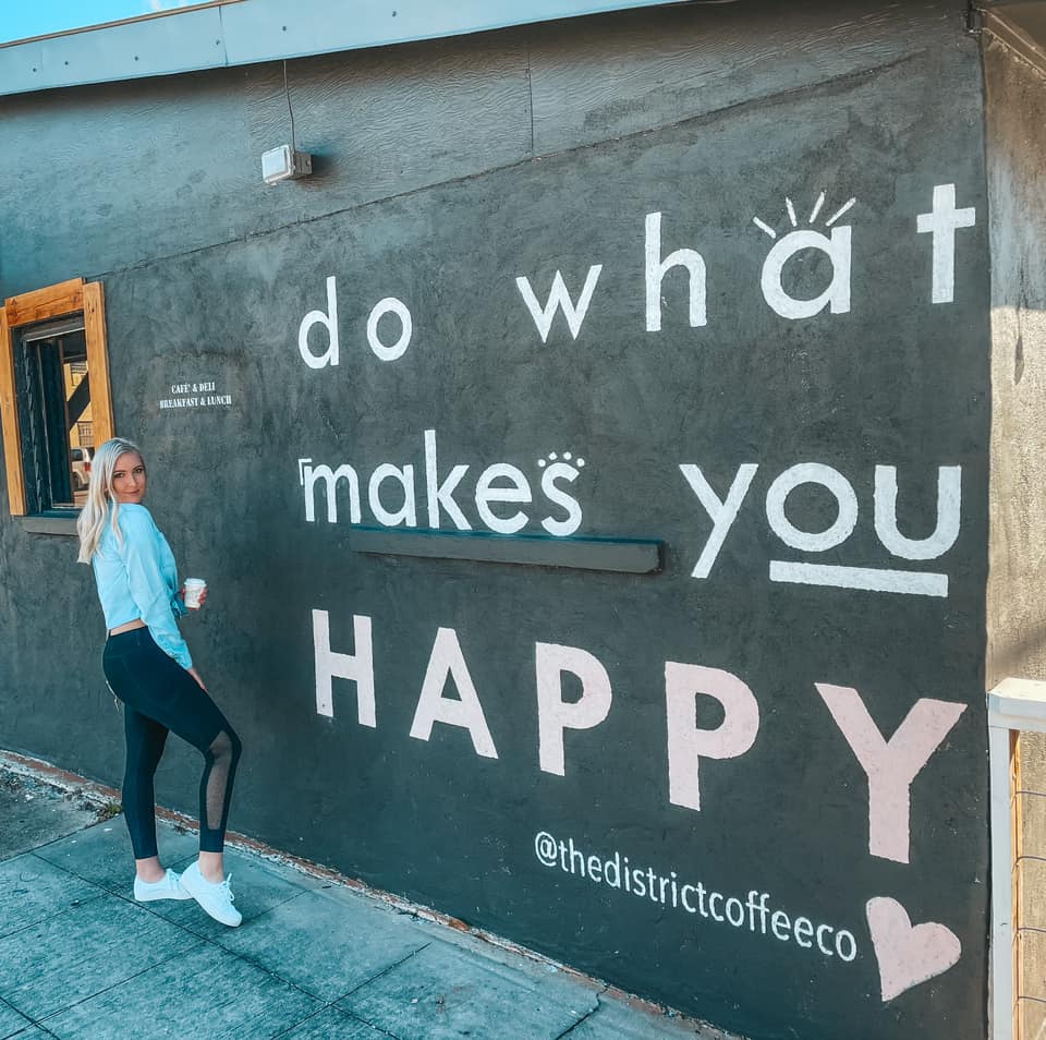 mural that reads "do what makes you happy" outside of The District Coffee Co in Ocean Springs, MS