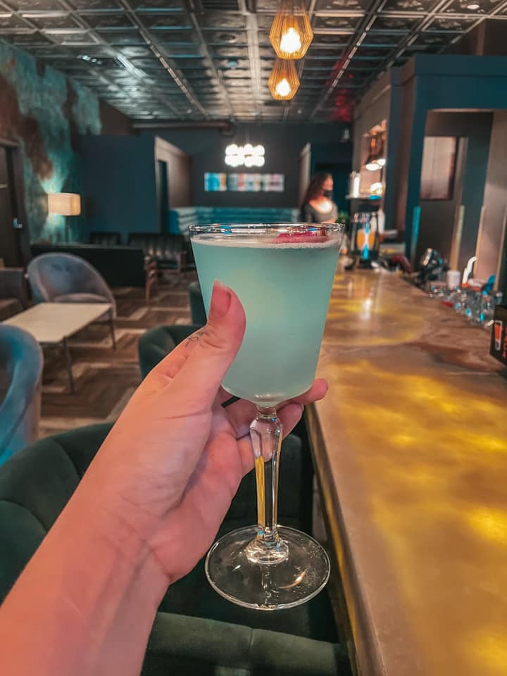 Beautiful blue cocktail called "Tropez" held up at Tropez in downtown St. Pete