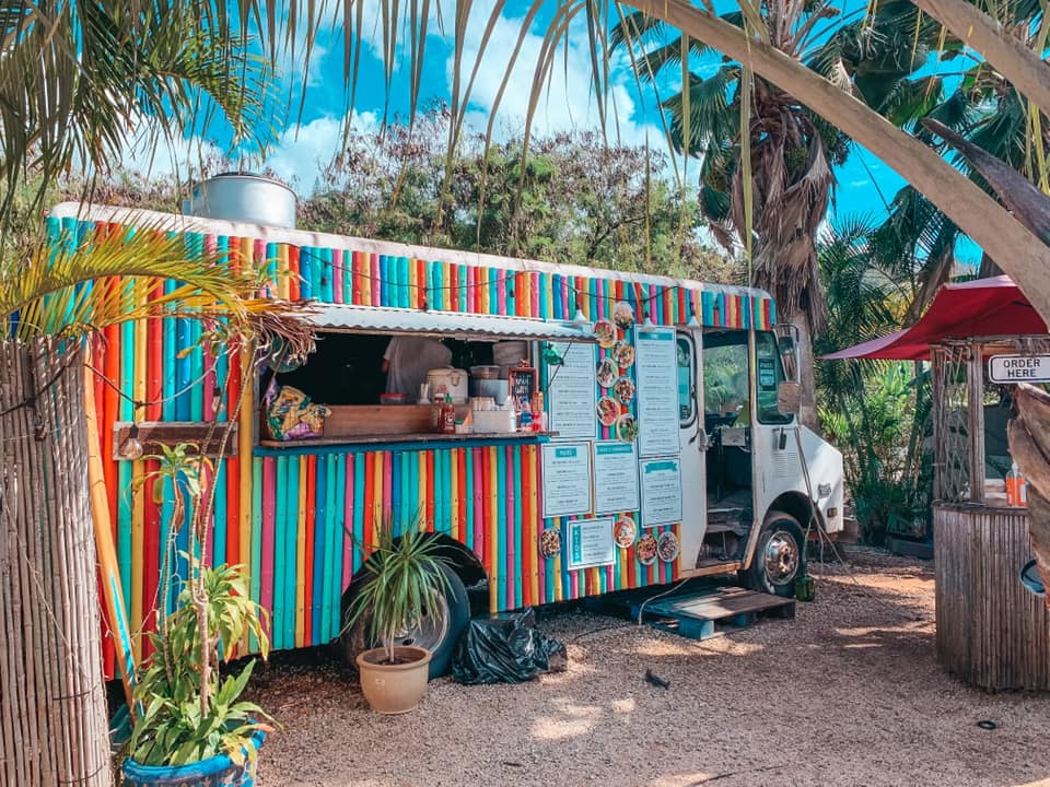 Brightly colored food truck on North Shore Aji Limo