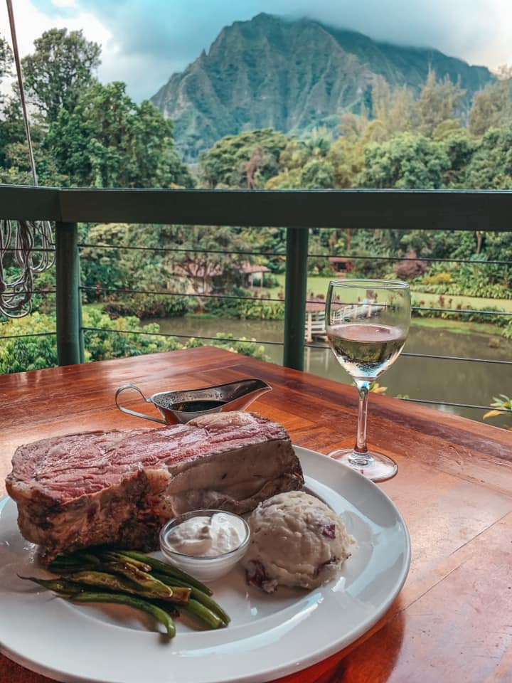 prime rib and glass of wine with mountain views in kaneohe at haleiwa joes
