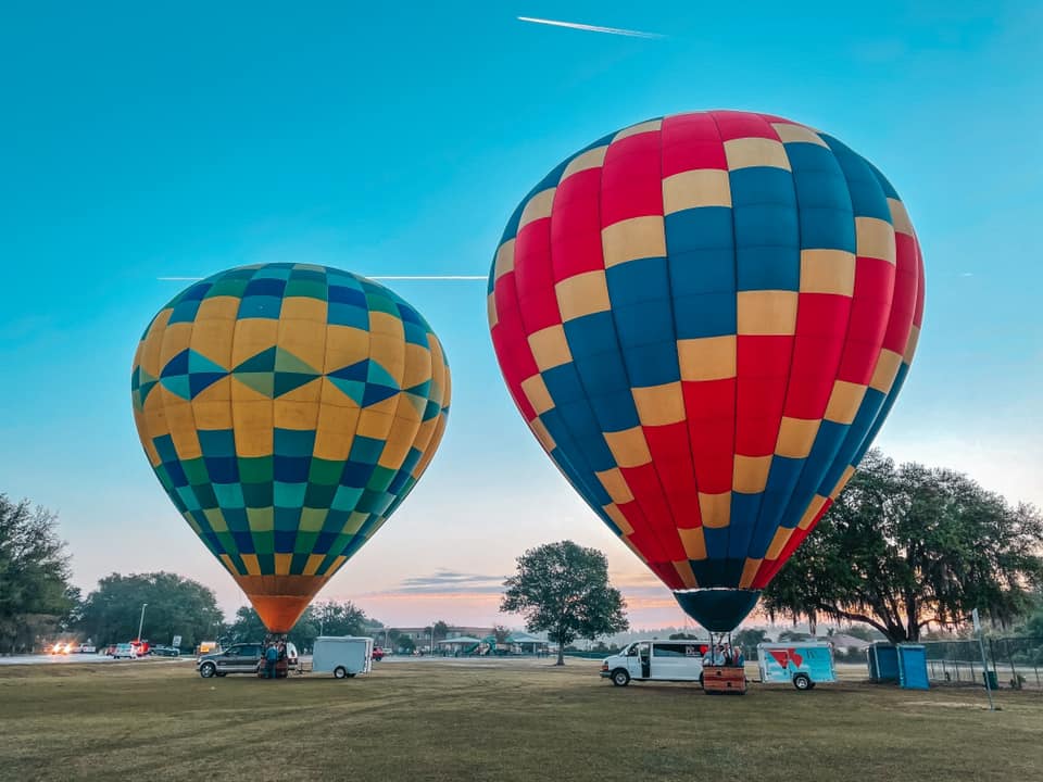 Two hot air balloons on the ground preparing to take off in Tampa Bay