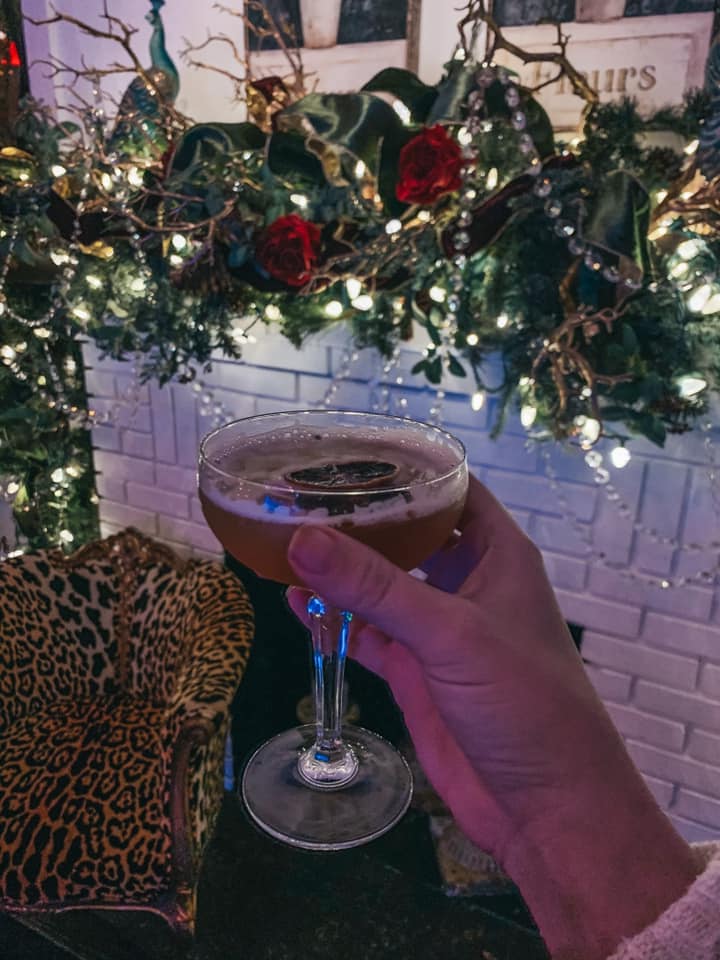 cocktail in front of fireplace at left bank bistro