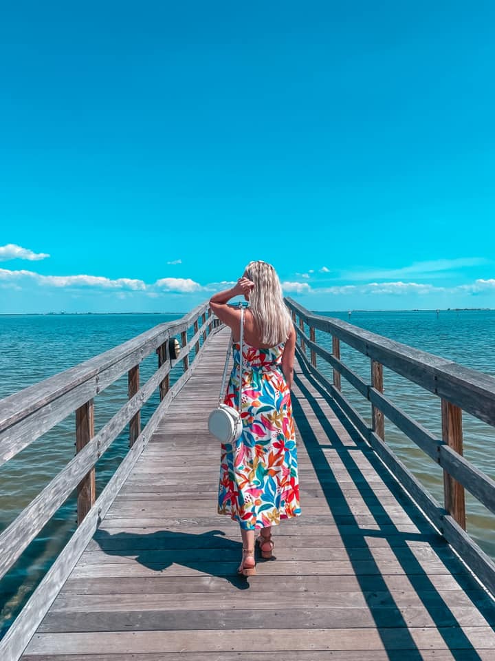 Walking down the Safety Harbor Pier on a sunny, clear sky day