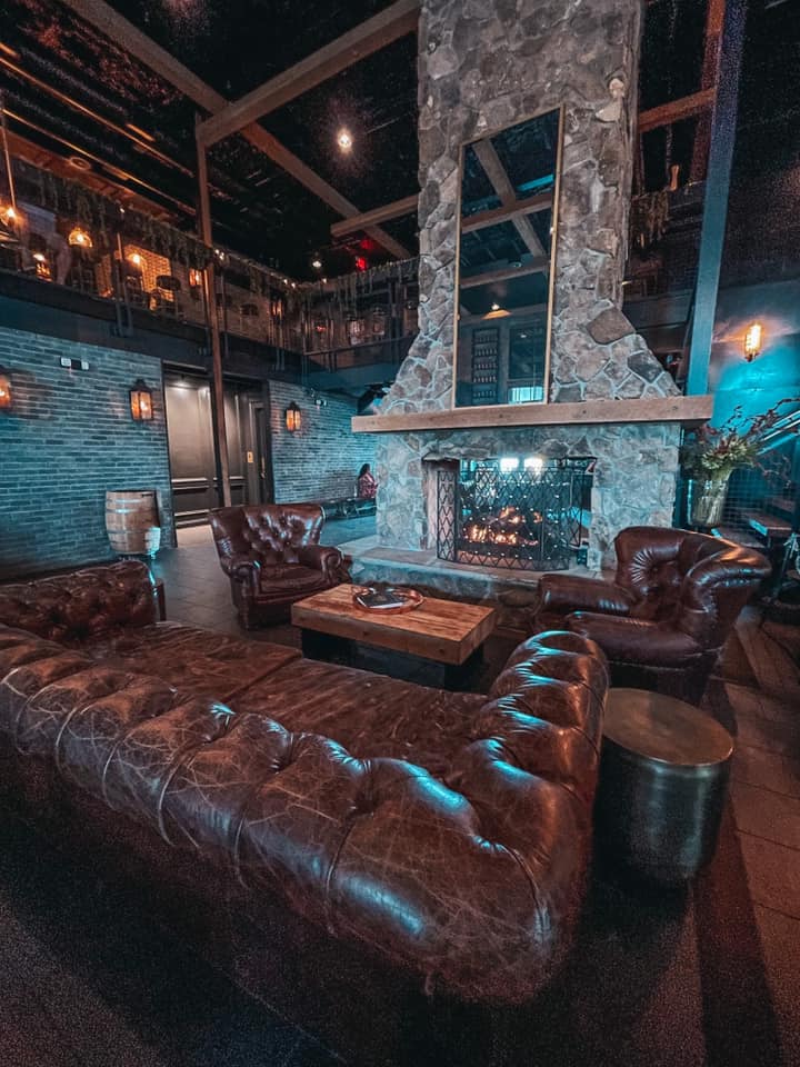 Leather couches and fireplace in The Urban Stillhouse