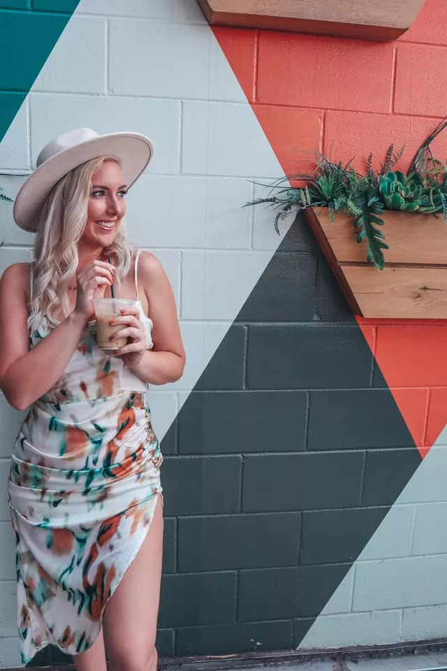 woman holding a coffee from one of the Things to Do in Austin