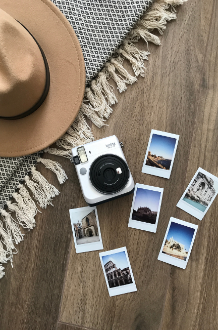 camera, hat, and polaroid photos