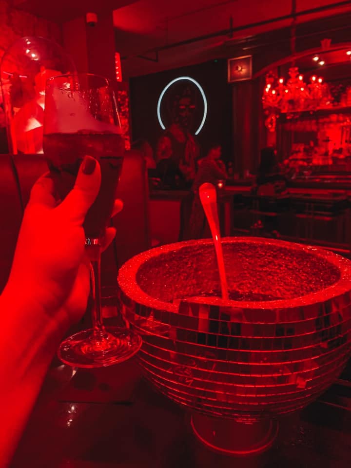 gluttony drink in a disco ball with a champagne flute from The Saint Speakeasy in downtown St. Pete