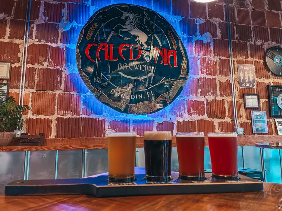 A beer flight with 4 different types of beer varying in colors from Caledonia Brewing in Dunedin