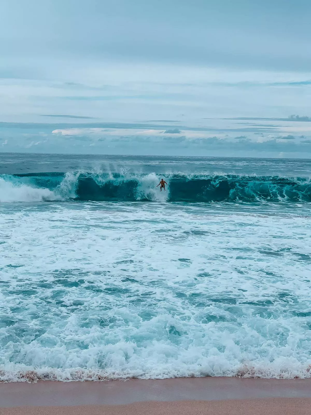 surfers surfing the Banzai Pipeline on Oahu's North Shore