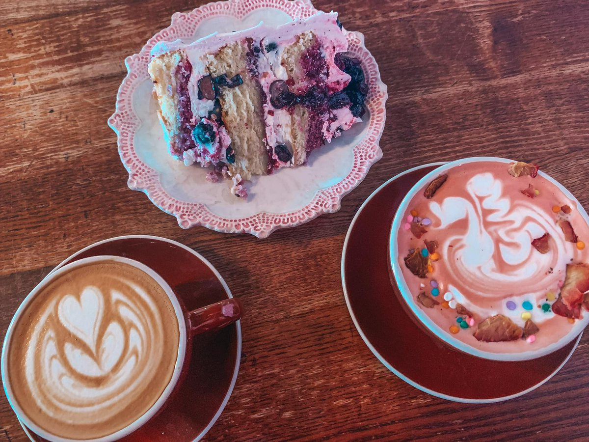 Vanilla and Strawberry Shortcake latte and slice of blueberry cake from Chocolate Pi in Tampa