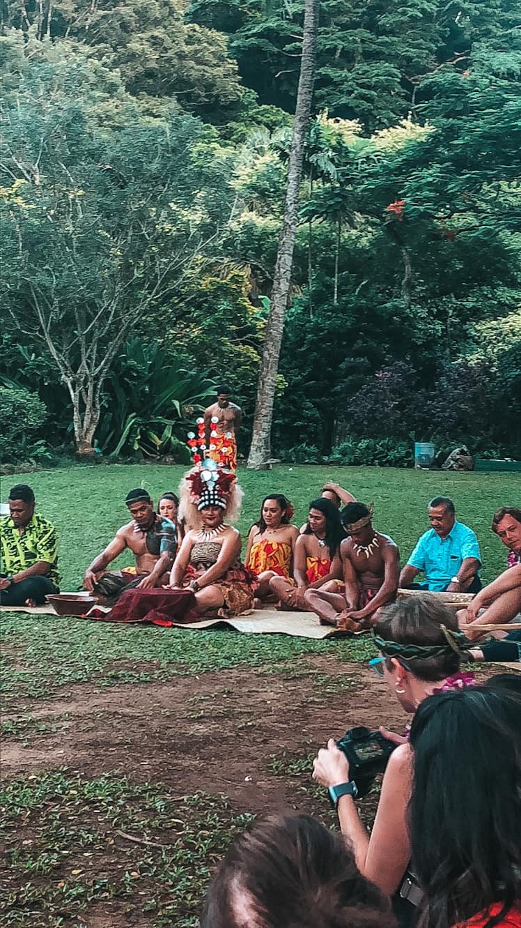 People gathered sitting in a circle at a luau on Oahu's North Shore