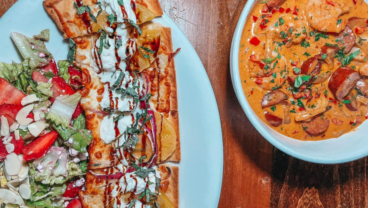 Shrimp and Grits and caprese flatbread with a salad from Mothers restaurant in Westchase