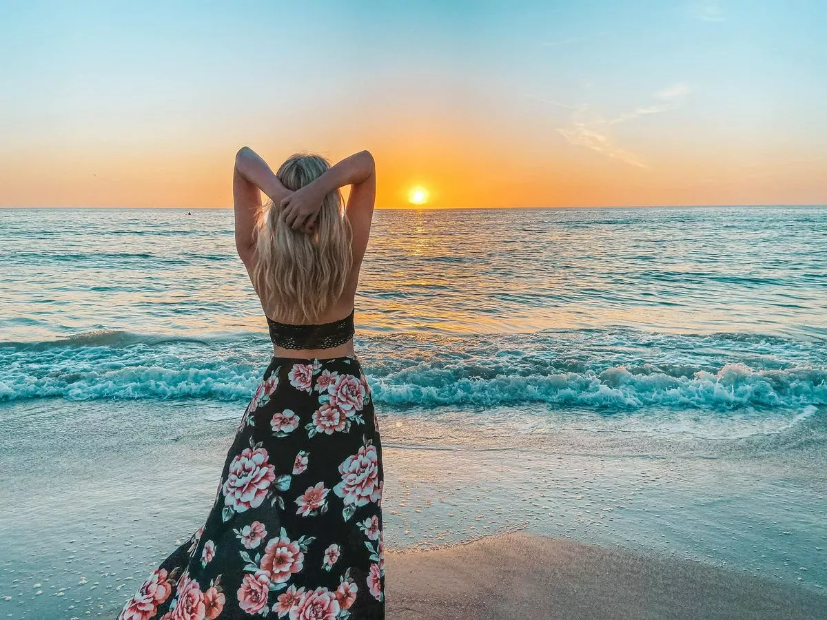 woman enjoying sunset on st pete beach for a florida bachelorette