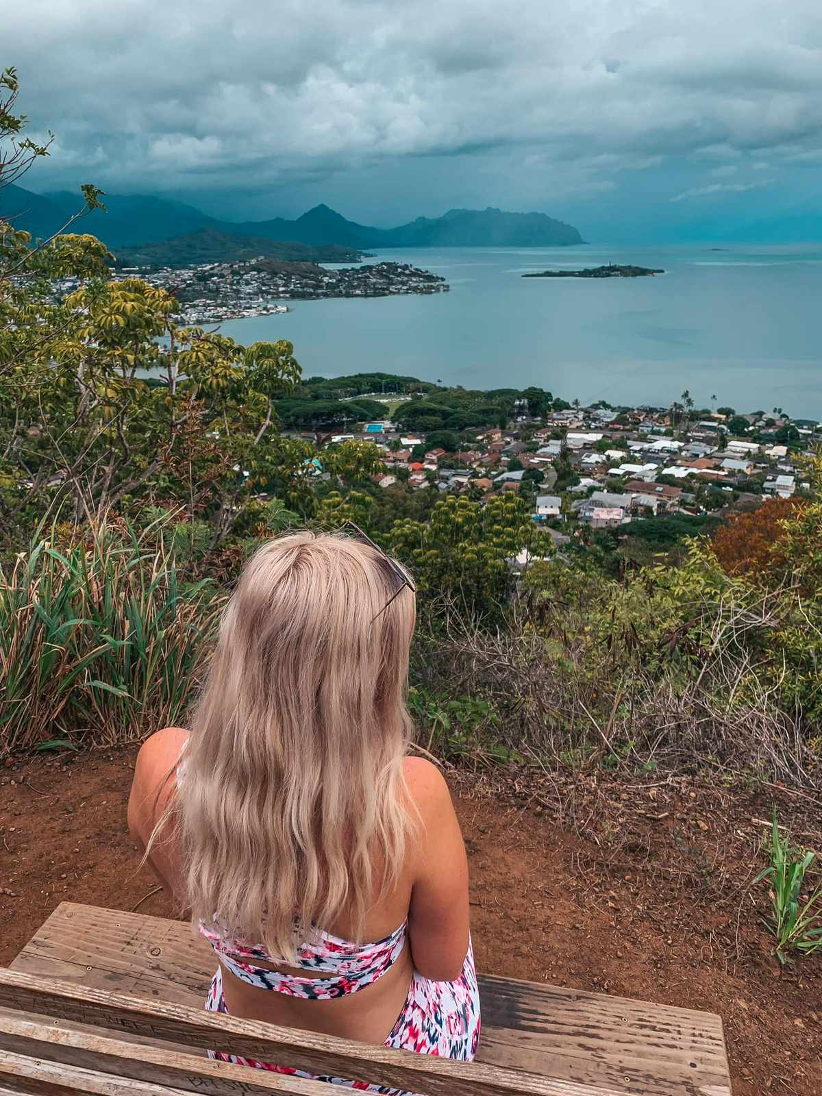 Woman sitting on a bench on the friendship garden trail in Kaneohe Oahu