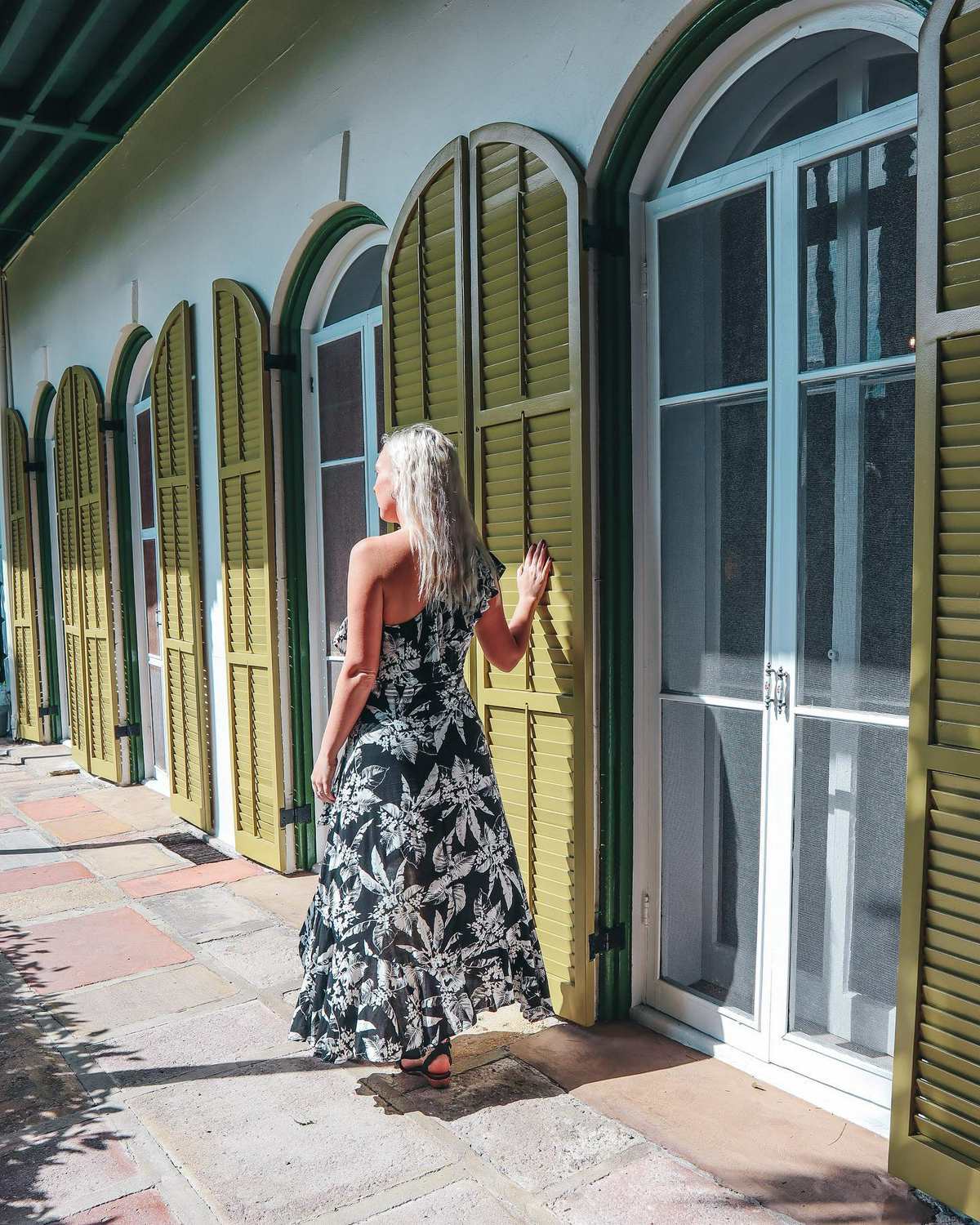 Woman walking around the Hemingway Home and Museum in Key West