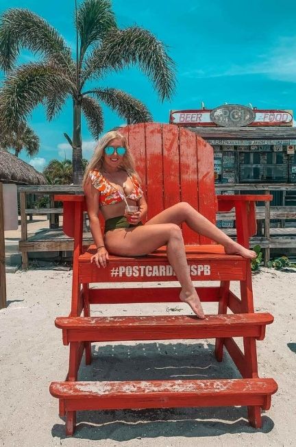 Woman on giant chair at PCI, one of the fun St. Pete Beach bars for a florida bachelorette