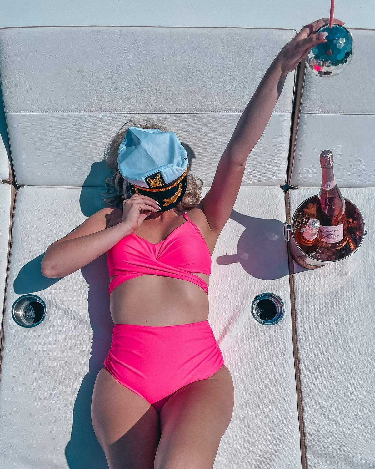 cute pose on a yacht with captains hat and drink in indian rocks beach