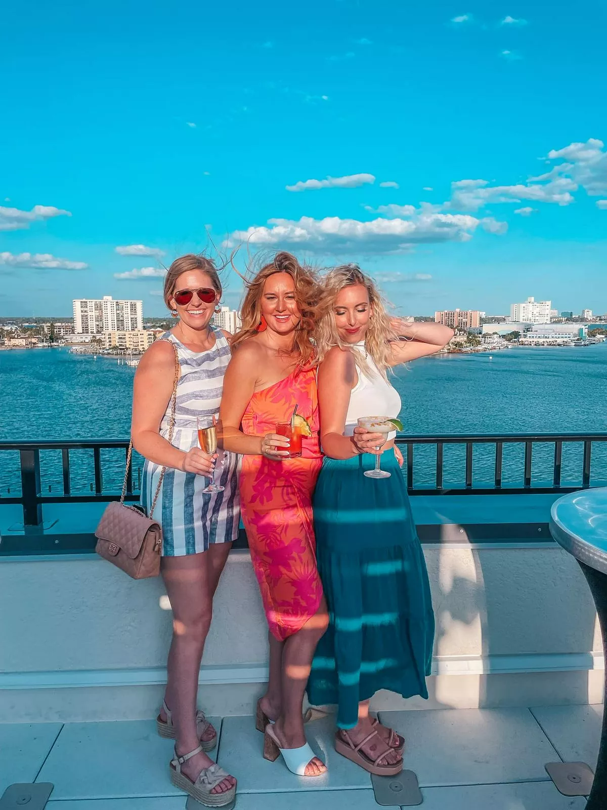 vue 360 clearwater friends posing at Vue 360 Clearwater Beach rooftop bar