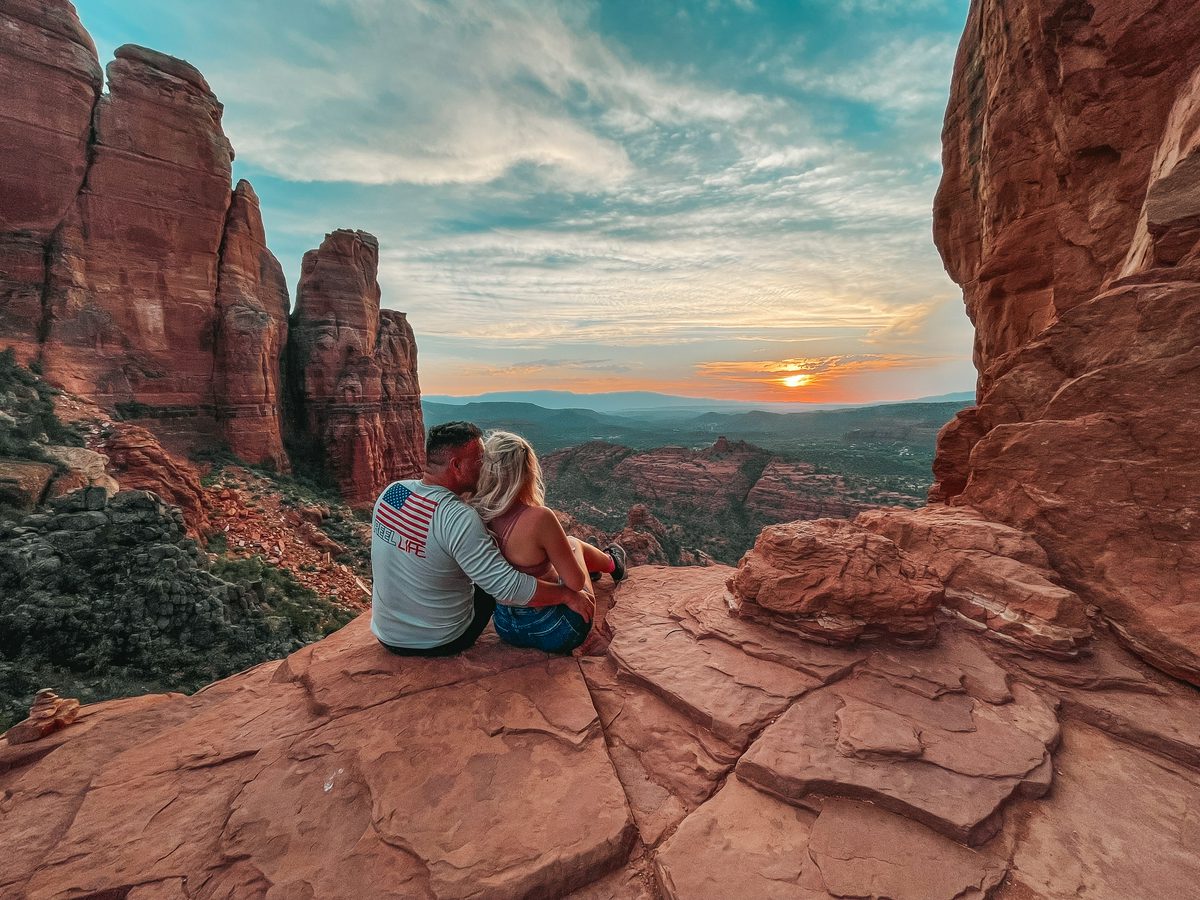 Couple holding each other at the top of Cathedral Rock