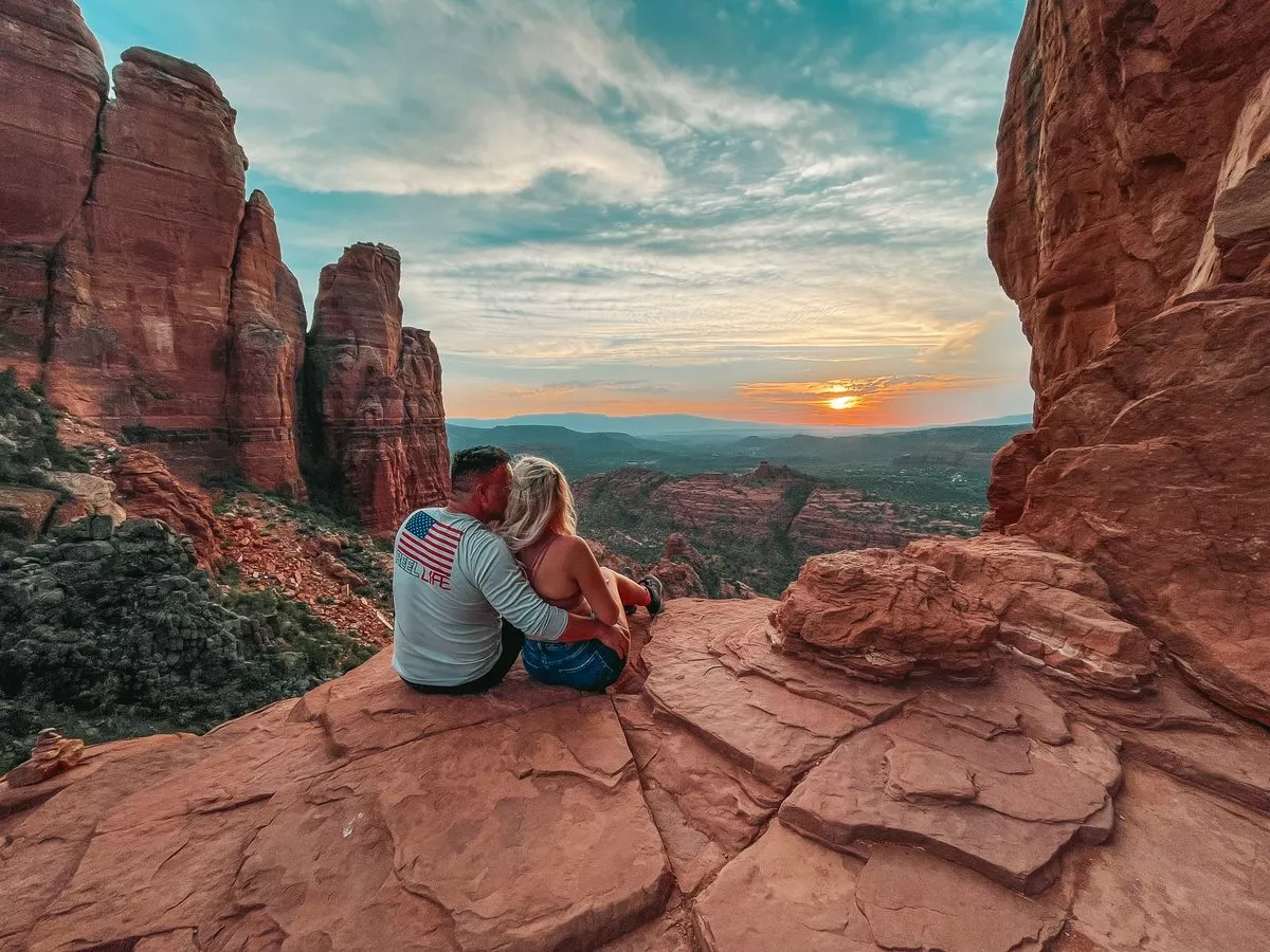 Couple holding each other at the top of Cathedral Rock