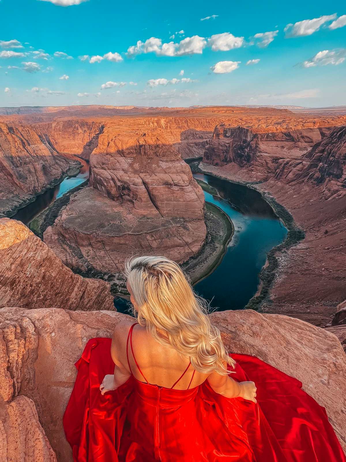 Woman in a red dress at Horseshoe Bend in Page Arizona