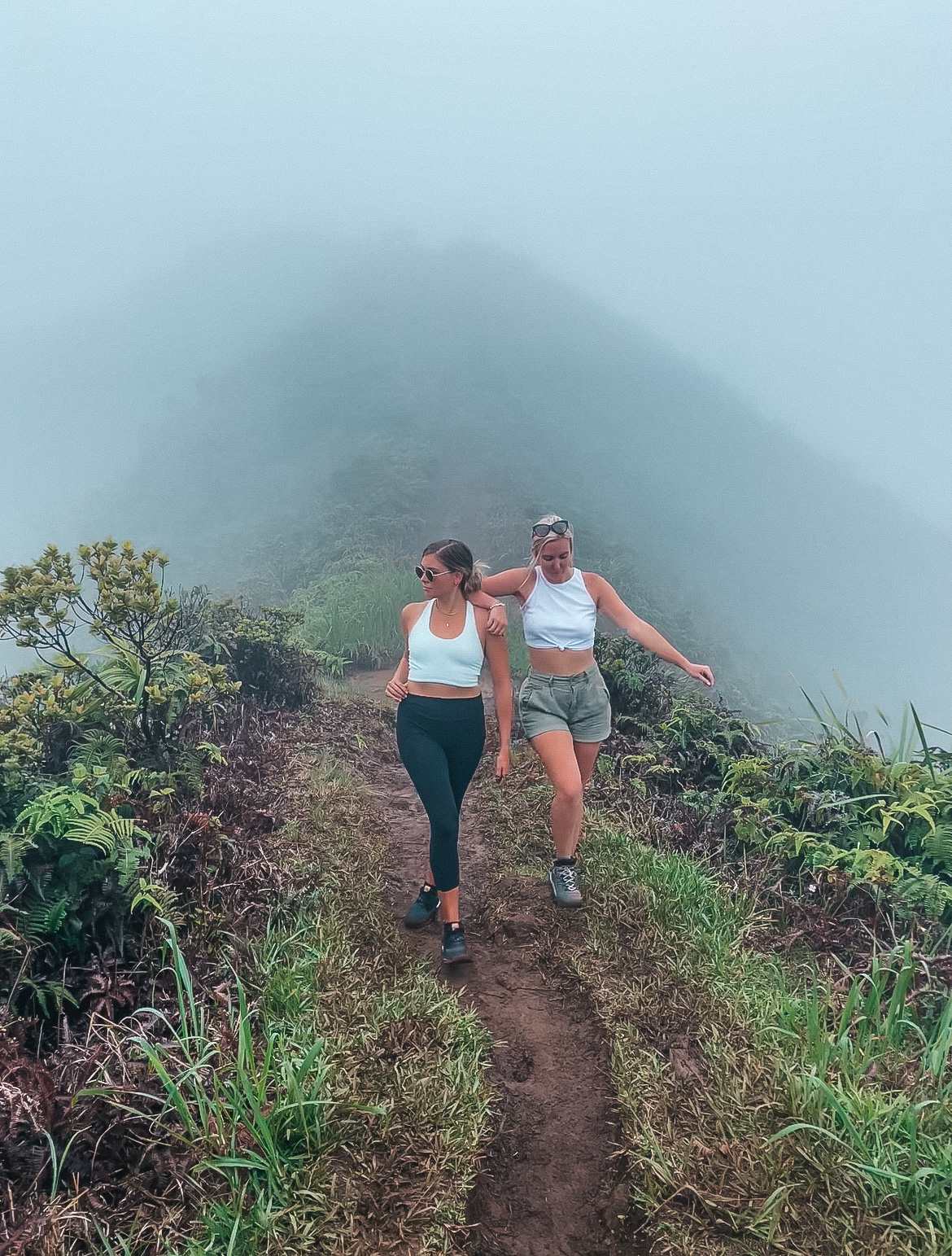 Girlfriends doing Wiliwilinui ridge hike on a foggy day