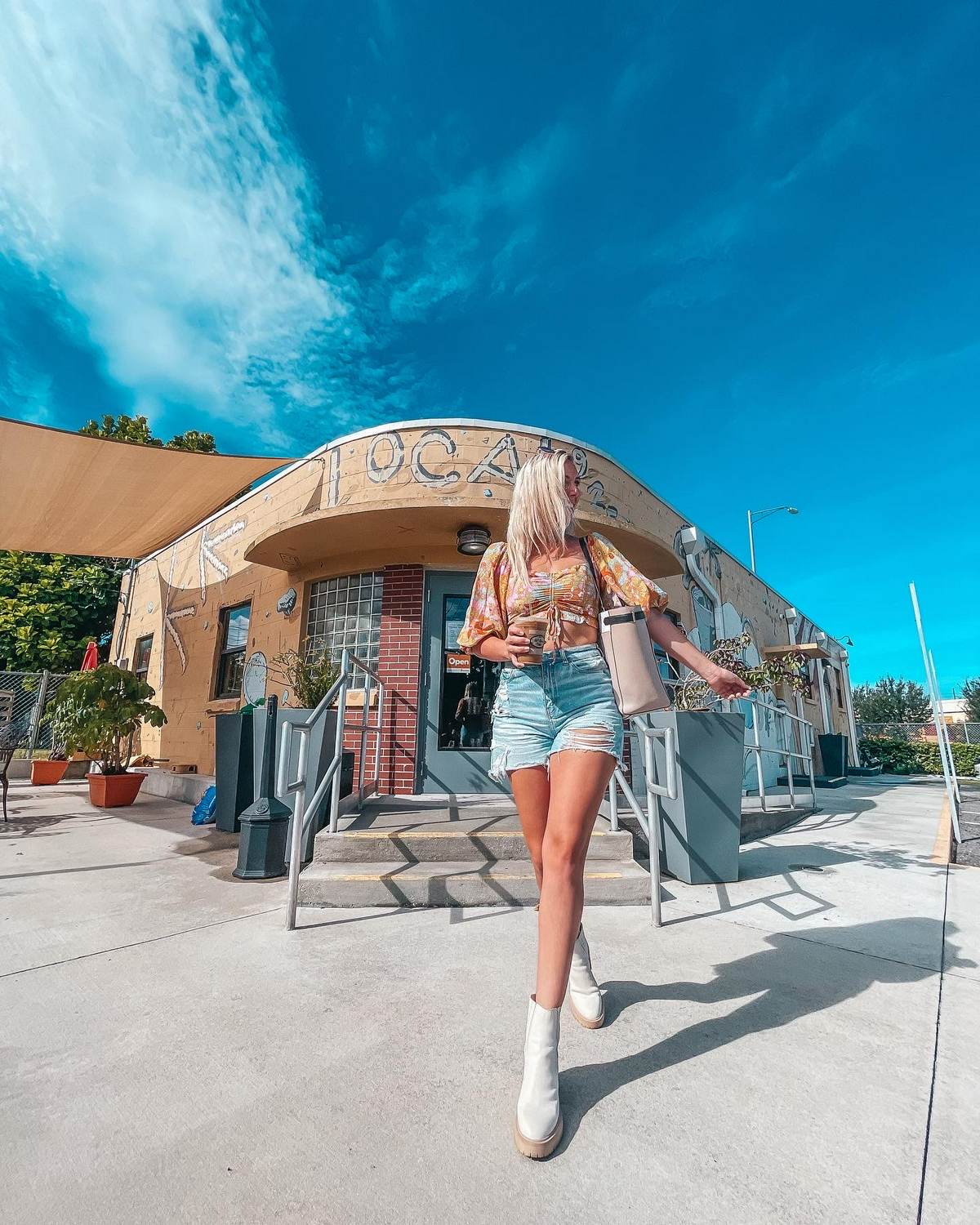 Posing with coffee outside of 22nd Street Coffee Shop in Ybor Tampa