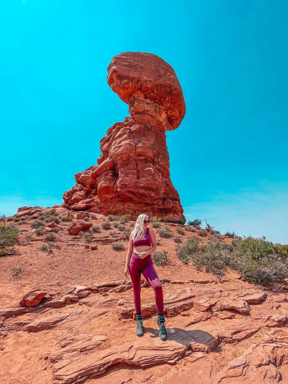 Posing at Balanced Rock in Arches National Park