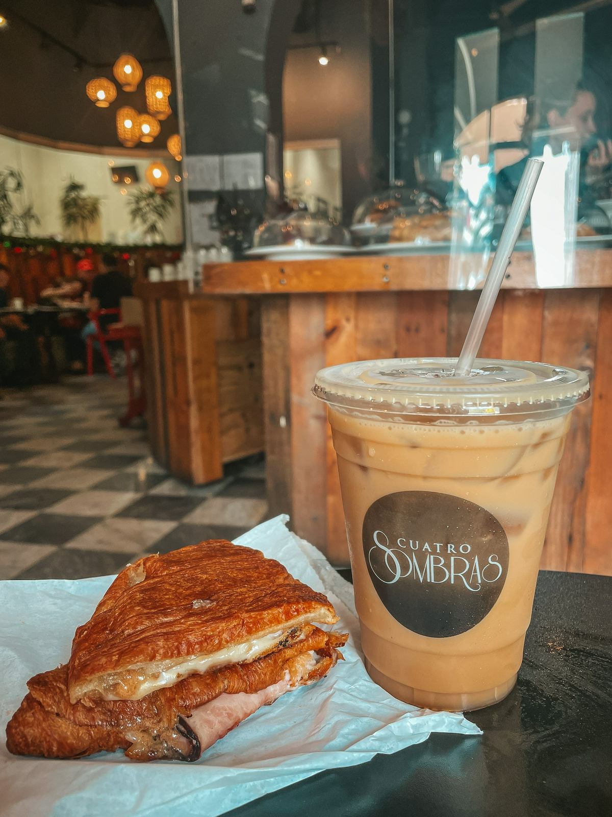 Ham, cheese, and guava butter croissant with a cold brew from Cuatro Sombras coffee shop in San Juan