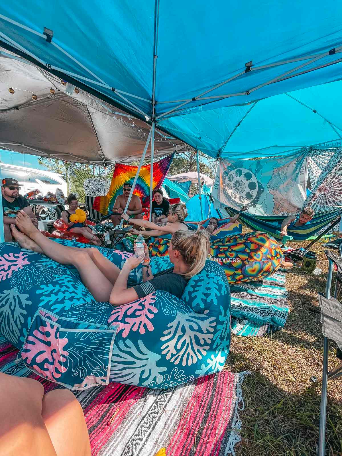 Destiny Snyder sitting on a bean chair and sharing camping festival packing list